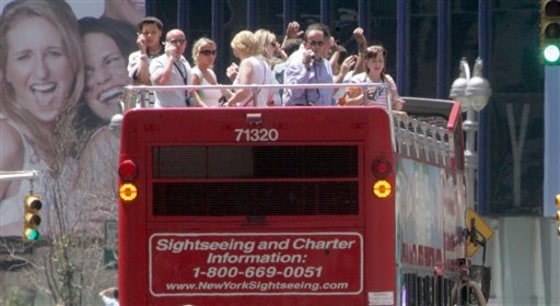 Passengers tour New York's Times Square atop a sightseeing bus.